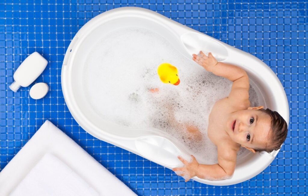 Baby playing with Disney bath toy