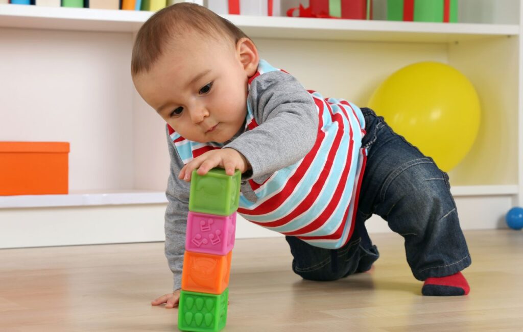 Toddler playing with wooden stacking toy